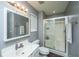 Well-lit bathroom with a glass-enclosed shower, neutral walls, and updated hardware at 311 Aberdeen Cir, Summerville, SC 29483