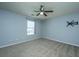 Neutral bedroom features a ceiling fan, window and carpeted floors at 311 Aberdeen Cir, Summerville, SC 29483