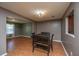 An open floor plan with dining and living room with wood-look flooring and neutral paint at 311 Aberdeen Cir, Summerville, SC 29483