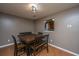 Cozy dining room featuring a rustic table, wood floors, and a view into the kitchen at 311 Aberdeen Cir, Summerville, SC 29483
