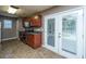 Open kitchen with stainless appliances, wood cabinets, and access to patio at 311 Aberdeen Cir, Summerville, SC 29483