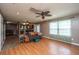 Open concept living room with hardwood floors, ceiling fan, and access to dining and kitchen at 311 Aberdeen Cir, Summerville, SC 29483