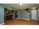 Living room with wood flooring, open to kitchen and staircase to upper level at 311 Aberdeen Cir, Summerville, SC 29483