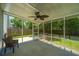 Screened patio with ceiling fan, outdoor seating, and backyard view at 311 Aberdeen Cir, Summerville, SC 29483