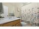 Clean bathroom featuring wooden vanity, ample mirror space and floral shower curtain at 330 Ripple Park Dr, Summerville, SC 29486