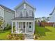 Charming two-story home featuring a cozy front porch, light blue siding, and well-manicured landscaping at 330 Ripple Park Dr, Summerville, SC 29486
