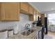 Granite countertops and stainless steel sink complement the cabinetry in this well-lit kitchen at 330 Ripple Park Dr, Summerville, SC 29486