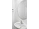 A bathroom sink with a chrome faucet and a round mirror at 3927 Four Poles Park Dr, North Charleston, SC 29405