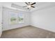 Spacious bedroom featuring a ceiling fan, a large window, and neutral-colored carpet at 3927 Four Poles Park Dr, North Charleston, SC 29405