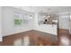 Open dining area featuring modern flooring, windows and view into adjacent kitchen at 3927 Four Poles Park Dr, North Charleston, SC 29405