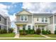 Charming two-story townhome showcasing neat landscaping and inviting curb appeal on a sunny day at 3927 Four Poles Park Dr, North Charleston, SC 29405