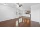 Bright and airy living room with modern flooring, ceiling fan, and view into kitchen at 3927 Four Poles Park Dr, North Charleston, SC 29405