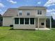Backyard view showcasing a covered patio, screened in porch, and green lawn at 412 Beverly Dr, Summerville, SC 29485