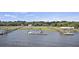 Scenic aerial showing private boat docks with multiple boats, along a tree-lined river at 4601 Apple St, North Charleston, SC 29405
