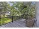 A lovely wooden deck with comfy seating offers a peaceful outdoor spot with a green view at 4601 Apple St, North Charleston, SC 29405