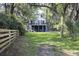 Private backyard with grass and wooded perimeter, creating a peaceful retreat-like setting at 4601 Apple St, North Charleston, SC 29405