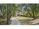 Exterior of home with stairway, grass and mature trees at 4601 Apple St, North Charleston, SC 29405