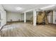 Bright unfinished basement with wood floors, staircase, and white columns at 4601 Apple St, North Charleston, SC 29405