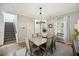Bright dining room features a modern chandelier, wood table, and natural light at 4601 Apple St, North Charleston, SC 29405