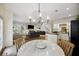 Open-concept dining and living area features a modern chandelier and connects seamlessly to the kitchen and living spaces at 4601 Apple St, North Charleston, SC 29405