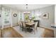 Bright dining room with hardwood floors, modern chandelier, and open to kitchen at 4601 Apple St, North Charleston, SC 29405