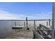 View of the dock with boat lift, bench seating, and calm water at 4601 Apple St, North Charleston, SC 29405