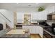 Well-lit kitchen features ample counter space, modern appliances, and stylish white cabinetry, ideal for culinary enthusiasts at 4601 Apple St, North Charleston, SC 29405