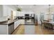Bright kitchen features white cabinets, stainless steel appliances, and a center island, perfect for cooking and entertaining at 4601 Apple St, North Charleston, SC 29405