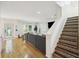 Inviting living room with hardwood floors, a gray sofa, and staircase at 4601 Apple St, North Charleston, SC 29405