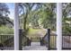 A covered porch shows views of the tree lined yard, driveway and other homes in the community at 4601 Apple St, North Charleston, SC 29405