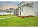 Beautiful backyard featuring green grass, walkway, and screened-in porch on a light-colored home at 501 Rhythm St, Summerville, SC 29486