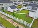 Expansive backyard with a white picket fence, lush green lawn, and a detached garage or shed at 501 Rhythm St, Summerville, SC 29486