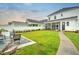 Lush backyard with a patio, walkway, well-manicured lawn, and screened-in porch at 501 Rhythm St, Summerville, SC 29486