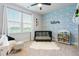 Charming Bedroom with blue wave wallpaper, a modern crib, and ample natural light at 501 Rhythm St, Summerville, SC 29486
