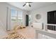 Sunlit Bedroom with modern ceiling fan, black door, and view of green space at 501 Rhythm St, Summerville, SC 29486