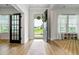 Inviting entryway with open door, wood floors, neutral decor, and a view to the yard at 501 Rhythm St, Summerville, SC 29486