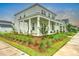 Attractive two-story home featuring a covered porch, beautiful landscaping, and inviting curb appeal at 501 Rhythm St, Summerville, SC 29486