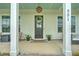 Inviting front porch with decorative wreath, stylish lighting fixture, and comfortable seating at 501 Rhythm St, Summerville, SC 29486
