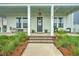 Inviting front porch with comfortable seating, decorative wreath, and stylish outdoor decor at 501 Rhythm St, Summerville, SC 29486