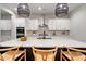 Kitchen featuring white cabinets, stainless steel appliances, island, and hardwood floors at 501 Rhythm St, Summerville, SC 29486