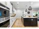 Spacious kitchen featuring white countertops and cabinetry, stainless appliances, and hardwood floors at 501 Rhythm St, Summerville, SC 29486