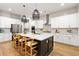 Modern kitchen featuring white cabinets, stainless steel appliances, and an island with seating at 501 Rhythm St, Summerville, SC 29486