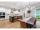 Modern kitchen and dining area featuring a large island, pendant lighting, and stainless steel appliances at 501 Rhythm St, Summerville, SC 29486