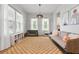 Bright living room features lots of light from big windows, neutral decor, and hardwood floors at 501 Rhythm St, Summerville, SC 29486