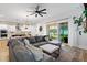 Cozy living room with a large sectional sofa, neutral decor, and view of the backyard at 501 Rhythm St, Summerville, SC 29486