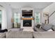 Living room with fireplace, mounted TV, neutral decor, and a comfortable sectional sofa at 501 Rhythm St, Summerville, SC 29486