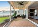 Cozy screened-in patio with comfortable seating, string lights, and views of the backyard at 501 Rhythm St, Summerville, SC 29486