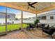Relaxing screened-in patio with comfortable seating, string lights, and a view of the green backyard at 501 Rhythm St, Summerville, SC 29486