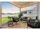 Inviting screened-in patio with comfortable seating, string lights, and a serene backyard view at 501 Rhythm St, Summerville, SC 29486