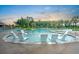 Community pool featuring submerged lounge chairs and palm trees for a resort-style experience at 501 Rhythm St, Summerville, SC 29486